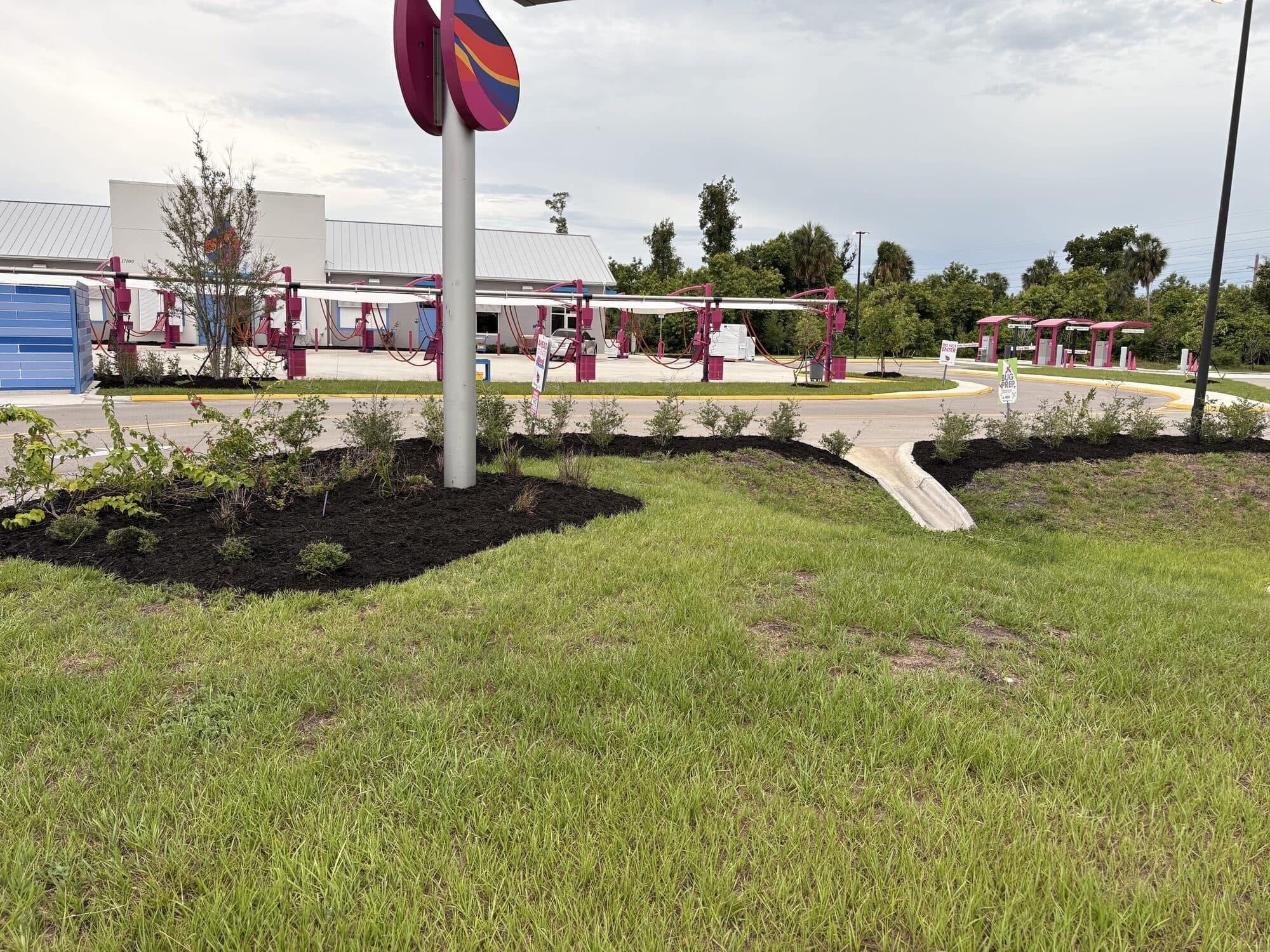 BCQ commercial landscape install at a monument sign entrance in Cape Coral